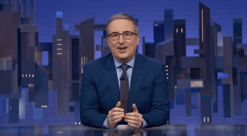 John Oliver Denounces Pete Hegseth’s Comments Celebrating David Ellison’s CNN Takeover & White House’s Iran War “Hype Videos”