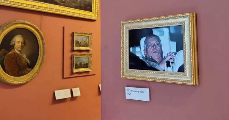 Activists hang André's photograph in the Louvre